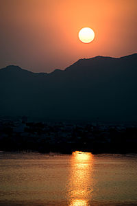 Scenic view of river at sunset