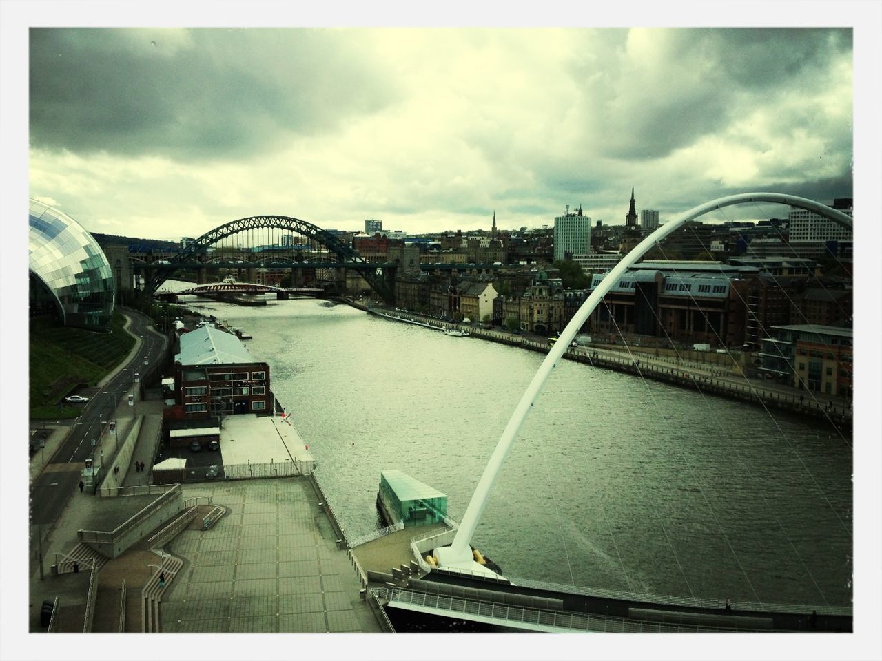 transfer print, architecture, built structure, building exterior, sky, auto post production filter, cloud - sky, city, cloudy, transportation, bridge - man made structure, cloud, mode of transport, nautical vessel, river, water, day, connection, travel destinations, travel