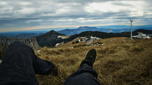 Low section of person relaxing on land