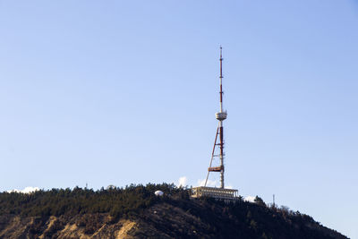 Low angle view of communications tower against clear sky