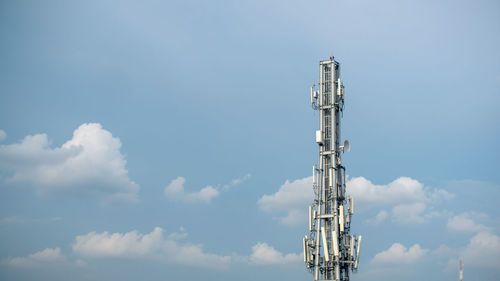 Low angle view of communications tower against sky