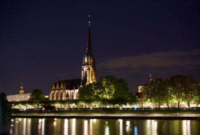 Illuminated building against sky at night