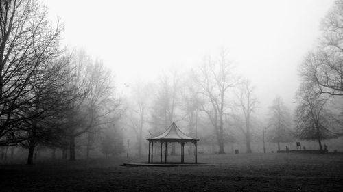 Gazebo in park against sky during winter