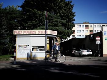 Man with bicycle on road in city