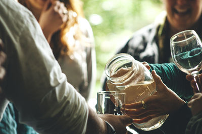 Midsection of people having drinks