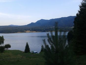 Scenic view of lake and mountains against sky