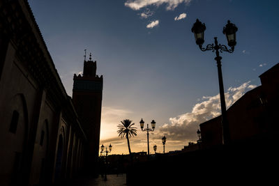 Low angle view of silhouette buildings against sky