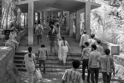 Group of people walking on walkway