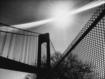 Low angle view of sun shining through clouds