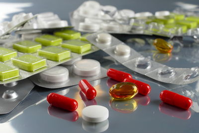 Close-up of pills and blister packs on table