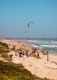 People at beach against sky