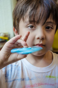 Close-up portrait of boy holding camera