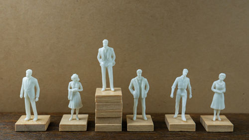 Statues on table against clear sky