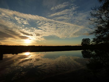 Scenic view of lake against sky during sunset