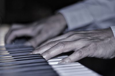 Midsection of baby playing piano