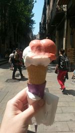 Woman holding ice cream on street