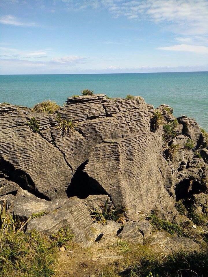 SCENIC VIEW OF SEA BY CLIFF