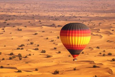 Hot air balloon flying over desert