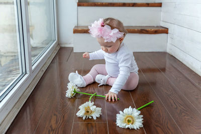 High angle view of girl playing with teddy bear