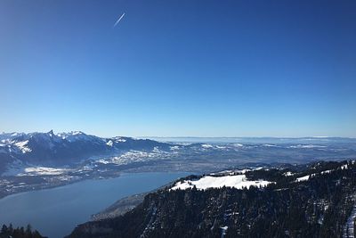 Scenic view of snowcapped mountains against clear blue sky