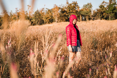 Woman with umbrella walking on field