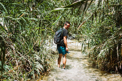 Full length of man walking on footpath in forest