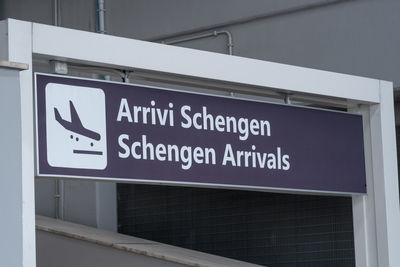 Low angle view of information sign on wall