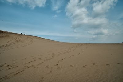 Scenic view of tottori sand dunes against sky