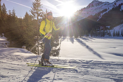 Man skiing on snowcapped mountain during winter