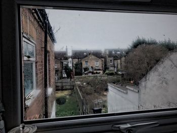 Panoramic view of city seen through glass window