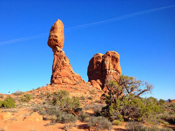 Low angle view of rock formations against blue sky