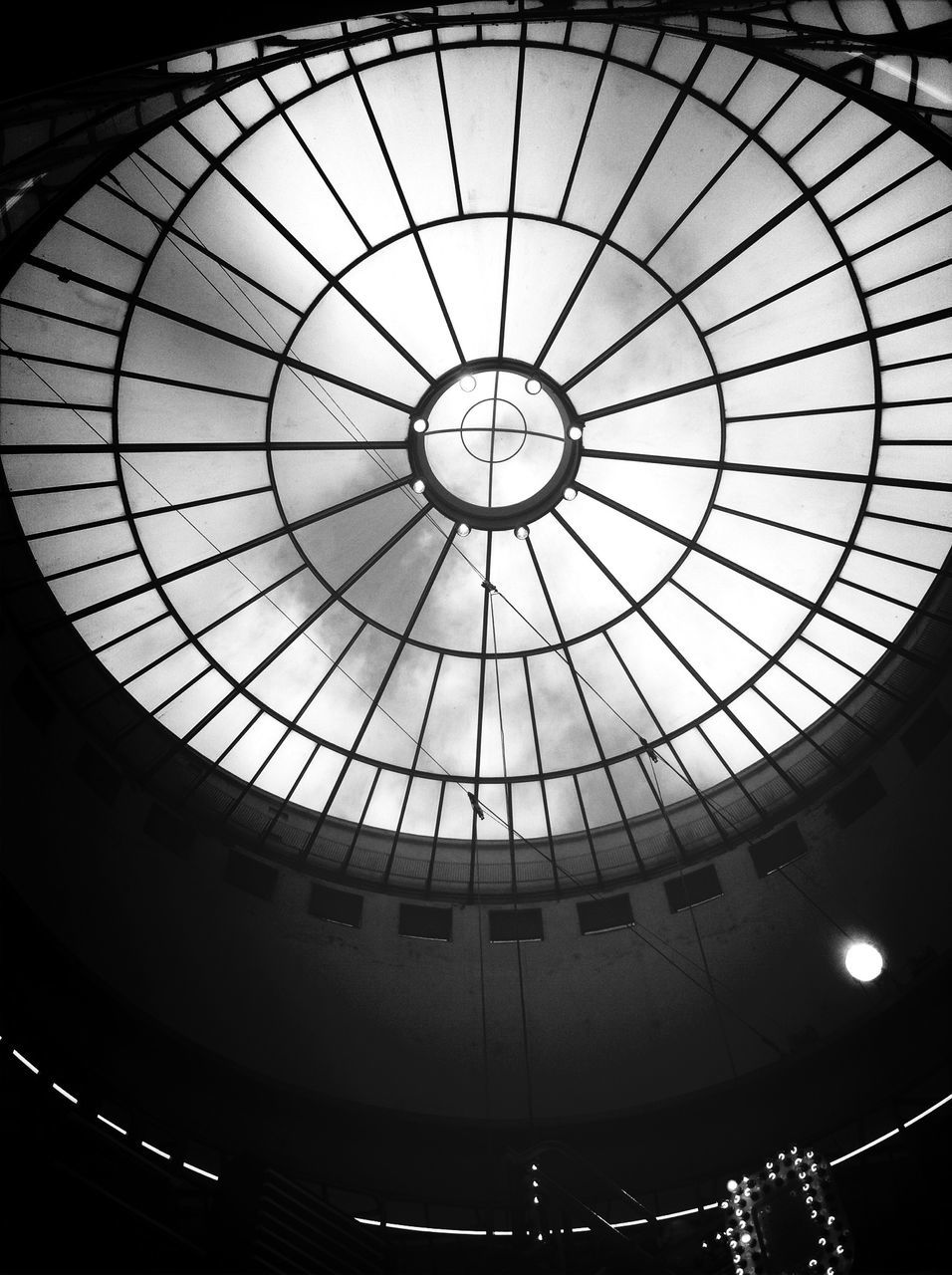 indoors, ceiling, low angle view, directly below, skylight, pattern, architecture, built structure, design, illuminated, circle, geometric shape, architectural feature, glass - material, lighting equipment, no people, shape, hanging, dome, spiral staircase