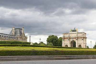 View of arc de triumph du carousel and the palace with dramatic clouds