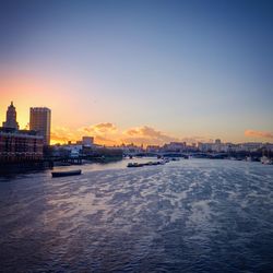 Buildings in city at sunset