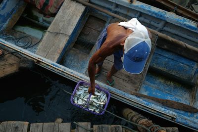 High angle view of man sitting on floor