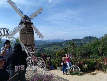 People at observation point against sky