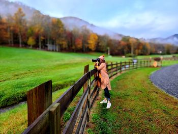 Rear view of woman walking on field