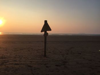 Scenic view of beach against sky during sunset