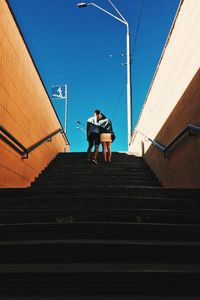 Low angle view of man standing on stairs