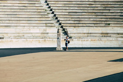 Rear view of man standing on staircase