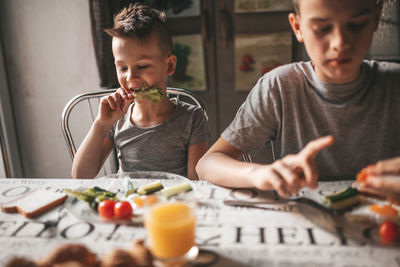 Boy having food on table