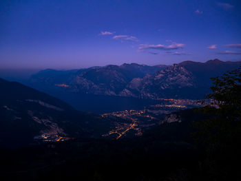 Aerial view of illuminated city against sky at night