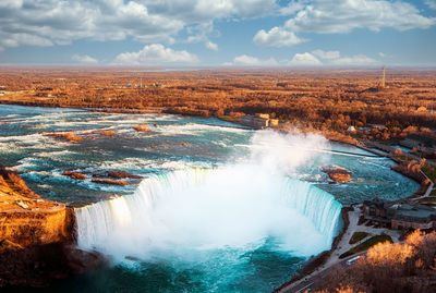 Scenic view of waterfall against sky