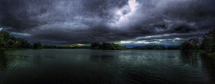 Scenic view of sea against cloudy sky