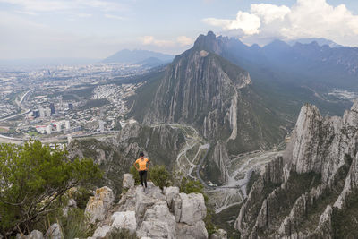 Panoramic view of people on mountain against sky