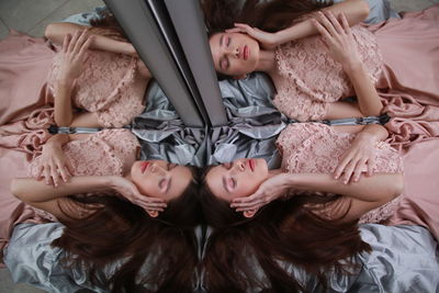 High angle view of girl lying down by mirror