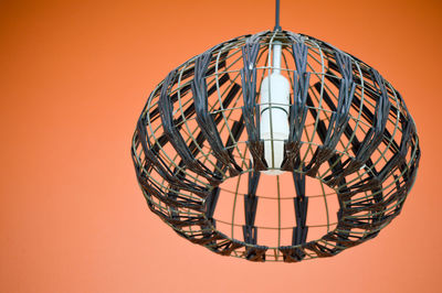 Low angle view of illuminated pendant lights hanging on ceiling