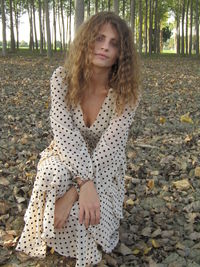 Portrait of teenage girl sitting on land