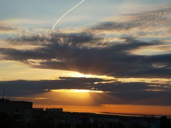 Silhouette buildings against sky during sunset