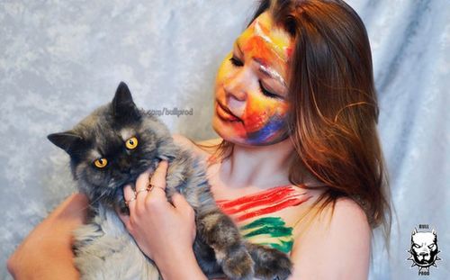 Portrait of young woman holding dog